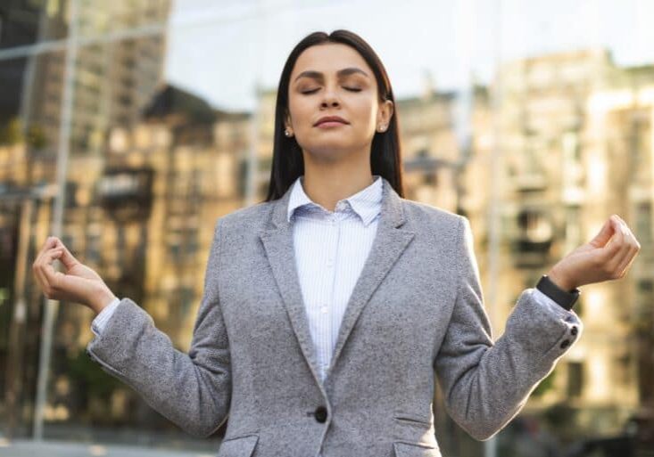 front-view-businesswoman-zen-pose (1)